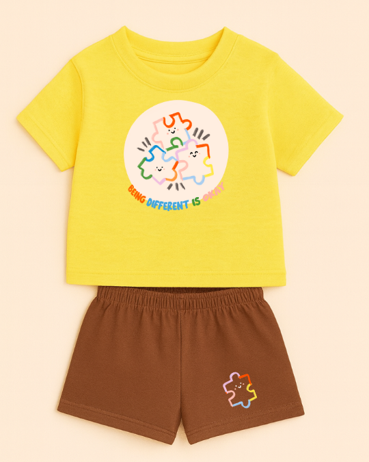Yellow t-shirt with a colorful graphic and brown shorts on a beige background