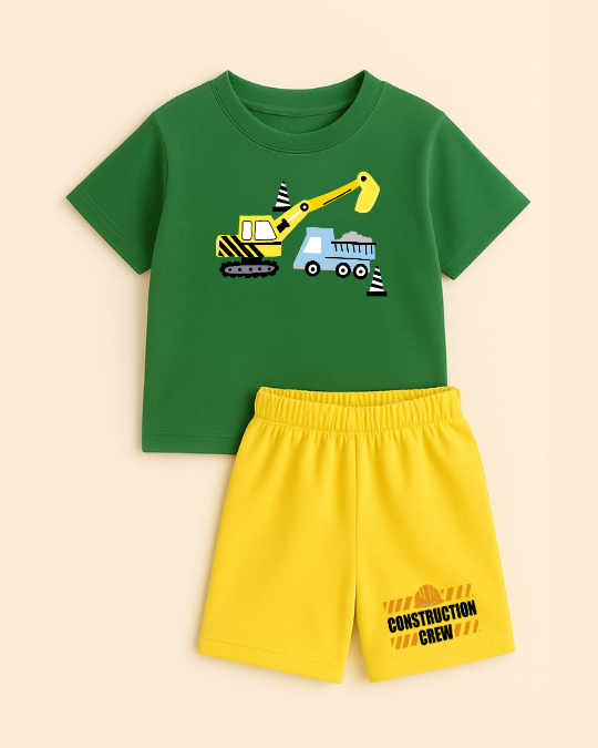 Green t-shirt with construction vehicle graphics and yellow shorts on a beige background
