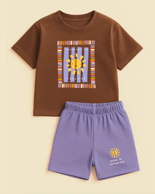 Children's brown shirt with sun design and purple shorts on a beige background