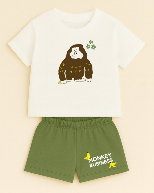Children's outfit with t-shirt and shorts featuring a monkey graphic and 'Monkey Business' text on a beige background.