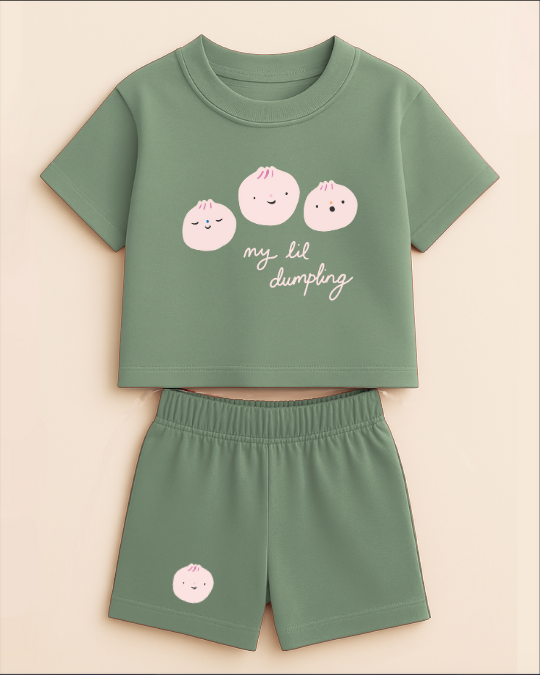 Green children's outfit with pink dumpling design on a beige background