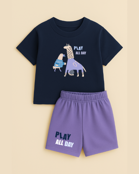 Navy t-shirt with giraffe graphic and 'Play All Day' text, paired with purple shorts on a beige background
