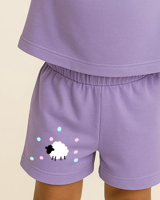 Purple shorts with a sheep design on a beige background