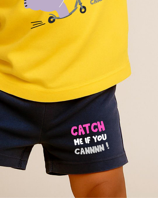 Yellow shirt with a cartoon character and black shorts with text on a beige background
