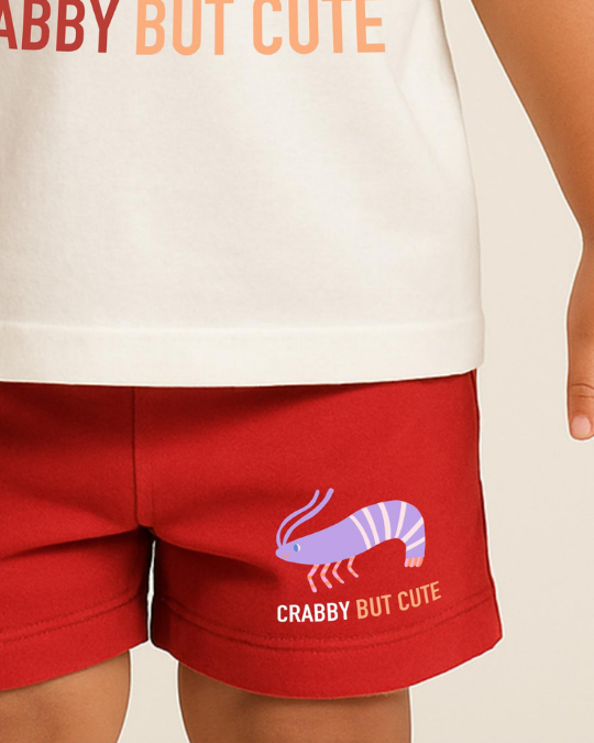 Red shorts with a crab graphic and 'Crabby But Cute' text on a beige background