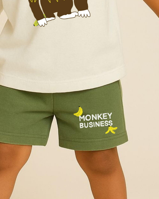 Green shorts with 'Monkey Business' text and banana graphics worn by a person.
