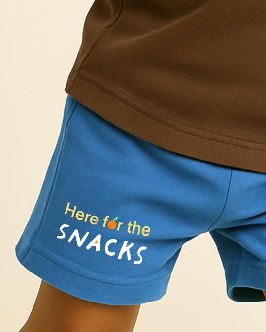 Blue shorts with 'Here for the SNACKS' text on a beige background