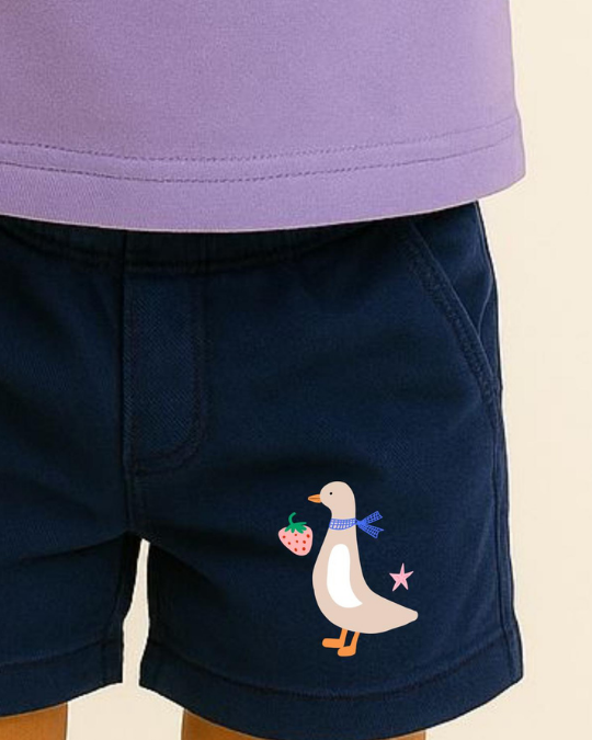 Navy shorts with a cartoon duck design on a beige background