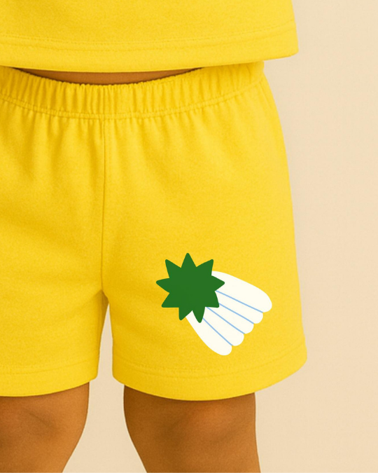 Yellow shorts with a green and white graphic on a beige background