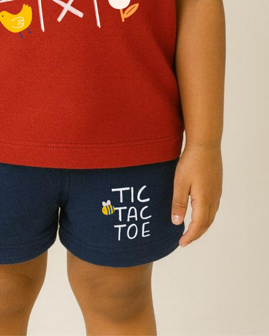 Navy shorts with 'Tic Tac Toe' text worn by a child, against a neutral background