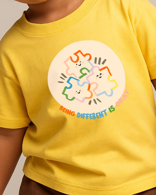 Yellow t-shirt with a colorful graphic and text on a plain background