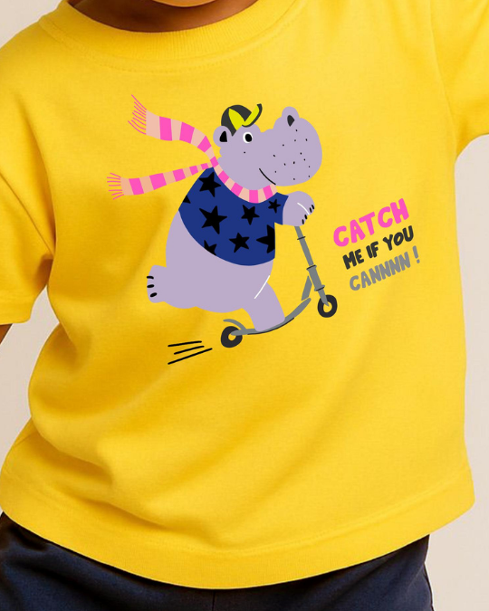 Yellow t-shirt with a cartoon hippo on a scooter and text, worn by a child.