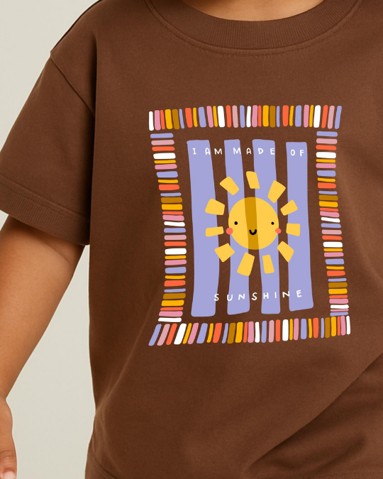 Brown t-shirt with a colorful sun graphic and text on a plain background