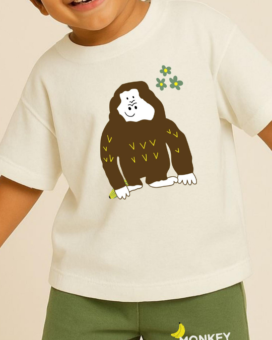 Child wearing a white t-shirt with a cartoon monkey design on a beige background