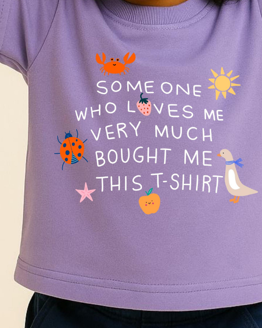 Purple t-shirt with colorful graphics and text on a beige background