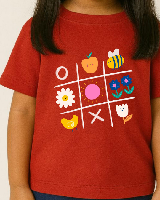Red t-shirt with a colorful tic-tac-toe design featuring animals and flowers.