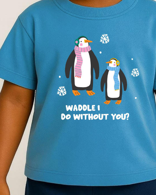 Blue t-shirt with penguin design and text on a plain background