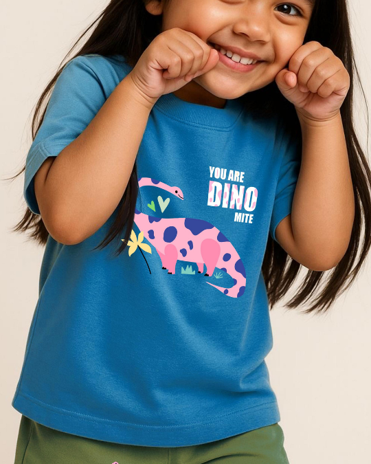 Child wearing a blue t-shirt with a dinosaur graphic and text