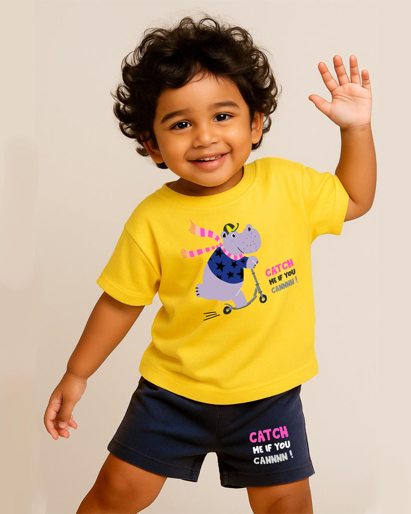 Child wearing a yellow t-shirt with a cartoon hippo design and text, waving on a beige background.