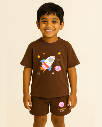 Child wearing a brown t-shirt with a rocket design on a beige background