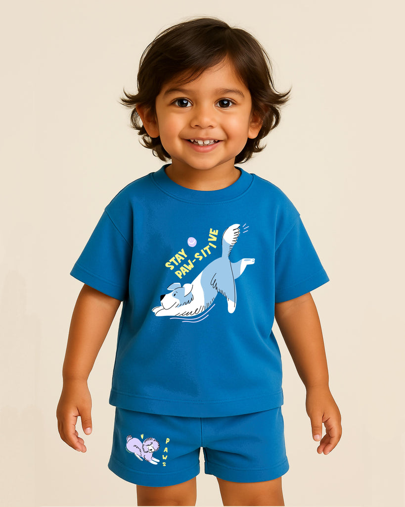 Child wearing a blue t-shirt and shorts with a cartoon design on a beige background