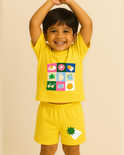 Child wearing a yellow outfit with colorful graphics on a beige background